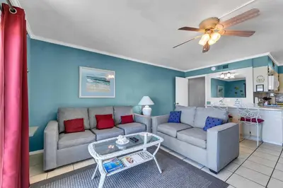 a living room with a couch and a table at The Summit 1209 in Panama City Beach
