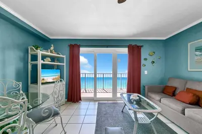 a living room with a couch and a view of the ocean at The Summit 1209 in Panama City Beach