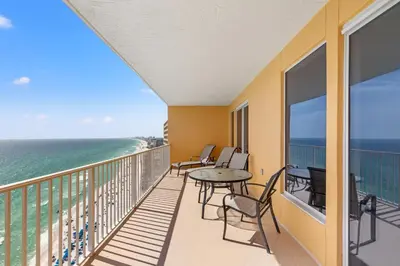 a balcony with a table and chairs and the ocean at Treasure Island Unit 2011: Sunset Sands, 2 Bed/2 Bath Retreat – Sleeps 8! in Panama City Beach