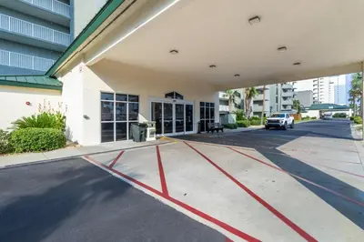 an empty parking lot in front of a building at Panama City Condo Rental Studio with Private Beach Access in Panama City Beach