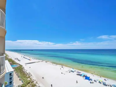 a view of the beach from the balcony of a resort at Tidewater 716 in Panama City Beach