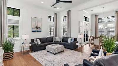 a living room with a couch and a table at Beach Sea-kers Retreat by AvantStay Rooftop Deck w Views Pool Luxury 5BDR in Inlet Beach