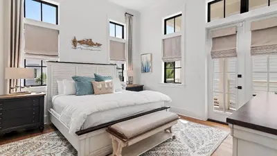 a white bedroom with a bed and windows at Beach Sea-kers Retreat by AvantStay Rooftop Deck w Views Pool Luxury 5BDR in Inlet Beach