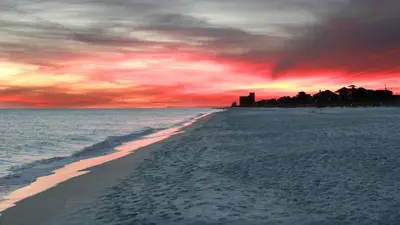 a view of a beach with a sunset at The Cake Cottage in Santa Rosa Beach