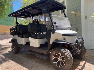 a golf cart parked in front of a house at The Cake Cottage in Santa Rosa Beach