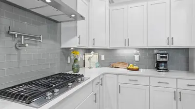 a white kitchen with a stove and white cabinets at Resorting To Happiness by AvantStay Close to the Beach w Pool Access in Inlet Beach