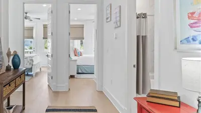 a hallway leading to a bedroom with a bed at Resorting To Happiness by AvantStay Close to the Beach w Pool Access in Inlet Beach