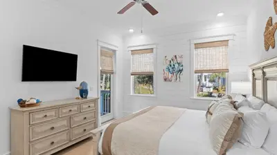 a bedroom with a bed and a flat screen tv at Resorting To Happiness by AvantStay Close to the Beach w Pool Access in Inlet Beach