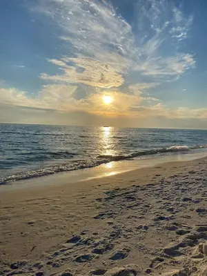 a sunset on a beach with the ocean at Edgewater Beach Resort Dream Villa! One Bedroom in Panama City Beach