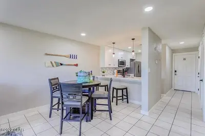 a kitchen and dining room with a table and chairs at Edgewater Beach Resort Dream Villa! One Bedroom in Panama City Beach