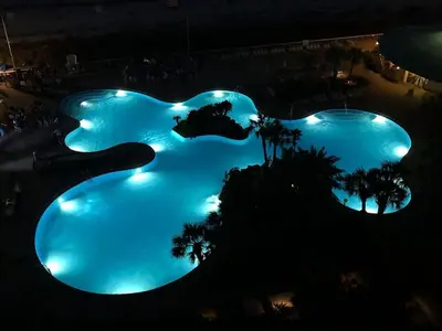 an overhead view of two pools at night at Edgewater Beach Resort Dream Villa! One Bedroom in Panama City Beach