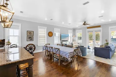 a kitchen and living room with a table and chairs at Narnia Grande Pointe Villa - Inlet Beach Pool & Clubhouse Access in Inlet Beach