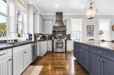 a large kitchen with white cabinets and a large island at Narnia Grande Pointe Villa - Inlet Beach Pool & Clubhouse Access in Inlet Beach