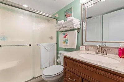 a bathroom with a sink and a toilet and a shower at Commodore 1205 with 2 beachfront masters in Panama City Beach