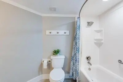 a bathroom with a toilet and a bath tub at Dunes of Panama 1506 in Panama City Beach
