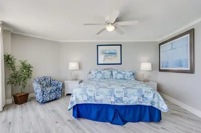 a bedroom with a bed and a ceiling fan at Dunes of Panama 1506 in Panama City Beach