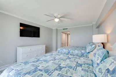 a bedroom with a bed and a ceiling fan at Dunes of Panama 1506 in Panama City Beach