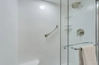 a bathroom with a shower with a glass door at Dunes of Panama 1506 in Panama City Beach
