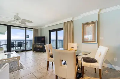 a living room with a table and chairs with a view at Watercrest 1710 - Sunsets in Paradise - Sleeps 8 in Panama City Beach