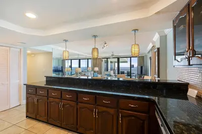a kitchen with a large counter and a dining room at Watercrest 1710 - Sunsets in Paradise - Sleeps 8 in Panama City Beach