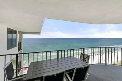 a balcony with a table and a view of the ocean at Watercrest 1710 - Sunsets in Paradise - Sleeps 8 in Panama City Beach