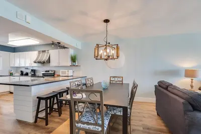 a kitchen and dining room with a table and chairs at Regency Towers 1018 Beachfront unit in Panama City Beach