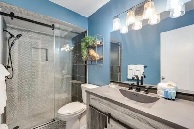 a bathroom with a toilet and a sink and a shower at Regency Towers 1018 Beachfront unit in Panama City Beach