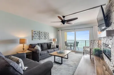 a living room with a couch and a tv at Regency Towers 1018 Beachfront unit in Panama City Beach