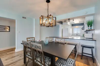 a dining room and kitchen with a table and chairs at Regency Towers 1018 Beachfront unit in Panama City Beach