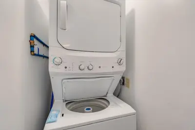 a white washer and dryer in a small room at Regency Towers 1018 Beachfront unit in Panama City Beach