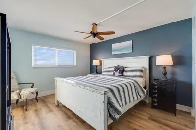 a bedroom with a white bed and a ceiling fan at Regency Towers 1018 Beachfront unit in Panama City Beach
