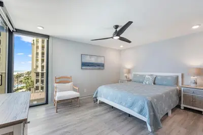 a bedroom with a bed and a ceiling fan at Edgewater Windward 508 - Newly Renovated Corner Condominium! in Panama City Beach