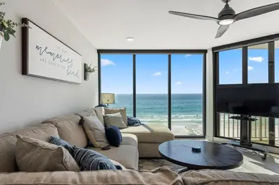 a living room with a couch and a flat screen tv at Edgewater Windward 508 - Newly Renovated Corner Condominium! in Panama City Beach