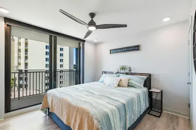 a bedroom with a bed with a ceiling fan at Edgewater Windward 508 - Newly Renovated Corner Condominium! in Panama City Beach