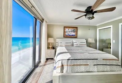 a bedroom with a bed with a view of the ocean at Watercrest 1403 - Stunning Ocean Overlook in Panama City Beach
