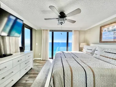 a bedroom with a large bed with a ceiling fan at Watercrest 1403 - Stunning Ocean Overlook in Panama City Beach