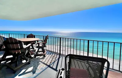 a balcony with a table and chairs and the ocean at Watercrest 1403 - Stunning Ocean Overlook in Panama City Beach