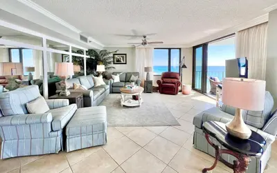 a living room with couches and chairs and the ocean at Watercrest 1403 - Stunning Ocean Overlook in Panama City Beach