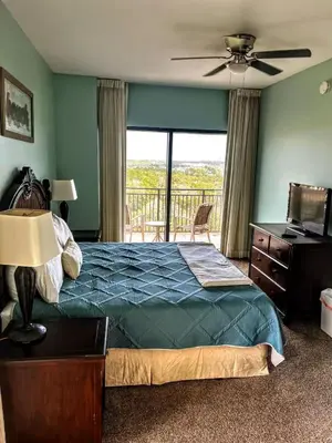 a bedroom with a bed and a view of a balcony at Origin Unit 911 in Panama City Beach