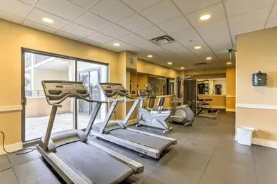 a gym with treadmills and machines in a room at Origin Unit 911 in Panama City Beach