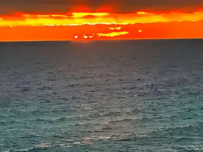 a sunset over a body of water with the ocean at Origin Unit 911 in Panama City Beach