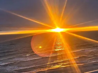 an image of the sun setting over the ocean at Origin Unit 911 in Panama City Beach