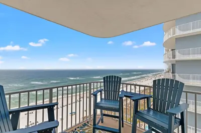 two chairs on a balcony overlooking the beach at Coastal Hideaway: Cozy Beachfront Studio – Sleeps 4 with Stunning Views! in Panama City Beach