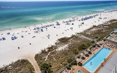 an overhead view of a beach with a lot of people at Coastal Hideaway: Cozy Beachfront Studio – Sleeps 4 with Stunning Views! in Panama City Beach