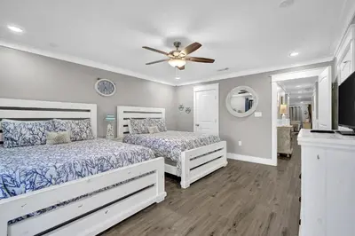 a bedroom with two beds and a ceiling fan at Edgewater Beach Resort stay at Cozy Beach Getaway! in Panama City Beach