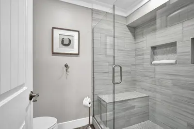 a bathroom with a toilet and a glass shower at Edgewater Beach Resort stay at Cozy Beach Getaway! in Panama City Beach