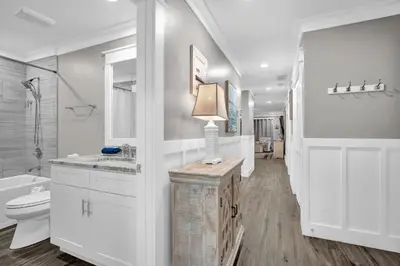 a white bathroom with a toilet and a sink at Edgewater Beach Resort stay at Cozy Beach Getaway! in Panama City Beach