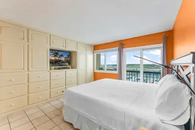 a bedroom with a large bed and a large window at Serenity Found at A-521 in Panama City Beach