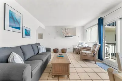 a living room with a couch and a table at Serenity Found at A-521 in Panama City Beach