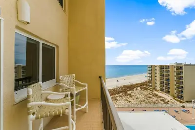 a balcony with chairs and a view of the beach at Serenity Found at A-521 in Panama City Beach